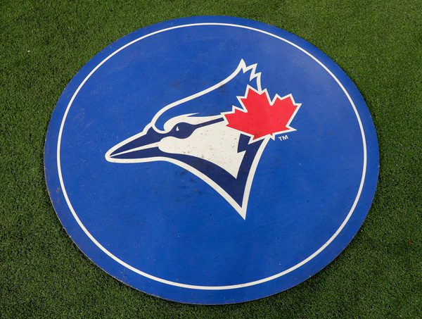 The Toronto Blue Jays logo displayed on a blue circular mat featuring a stylized blue jay head with a red maple leaf accent.